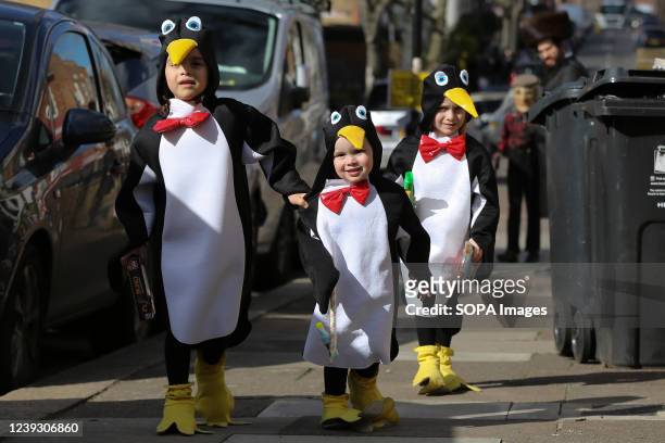 Orthodox Jewish children dressed in penguin costumes take part in the annual festival of Purim in Stamford Hill, north London. Purim festival is...