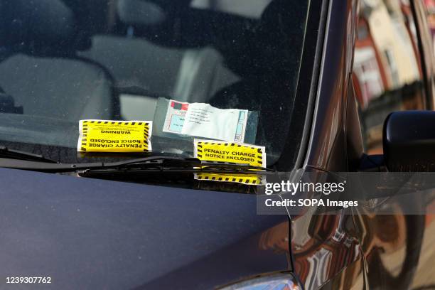 Penalty charge notices given to a car parked illegally.