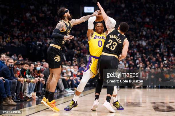 Russell Westbrook of the Los Angeles Lakers is defended by Gary Trent Jr. #33 and Fred VanVleet of the Toronto Raptors during the first half of their...