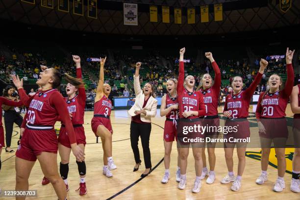 Head Coach Dawn Plitzuweit of the South Dakota celebrates with her team at the first round of the 2022 NCAA Women's Basketball Tournament against Ole...