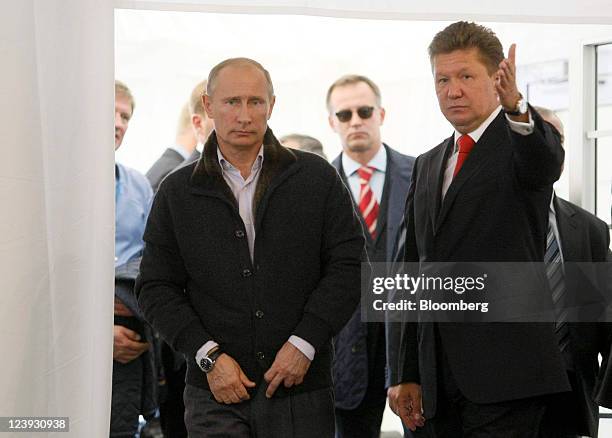 Vladimir Putin, Russia's prime minister, left, arrives with Alexei Miller, chief executive officer of OAO Gazprom, for the opening ceremony of the...