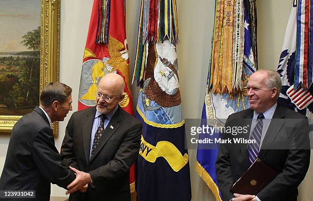 David Petraeus is congratulated by National Intelligence Director James Clapper and National Security Advisor John Brennan after he was sworn in to...