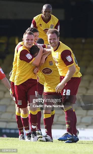 Arron Davies of Northampton Town is congratulated by team mate's Paul Turnbull, Kelvin Langmead, Ben Tozer and Lewis Young after scoring his sides...