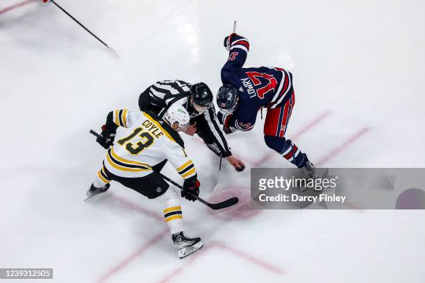 Charlie Coyle of the Boston Bruins gets set to take a second period face-off against Adam Lowry of the Winnipeg Jets at the Canada Life Centre on...