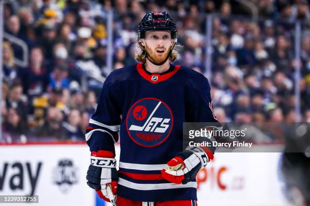 Kyle Connor of the Winnipeg Jets looks on as he gets set for a second period face-off against the Boston Bruins at the Canada Life Centre on March...