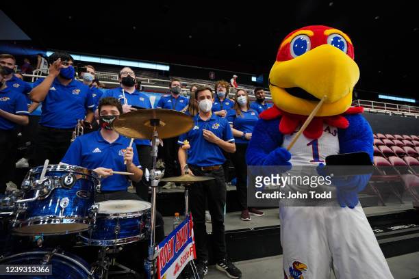 The Kansas Jayhawks mascot has fun with the university band before they take on the Georgia Tech Yellow Jackets during the first round of the 2022...