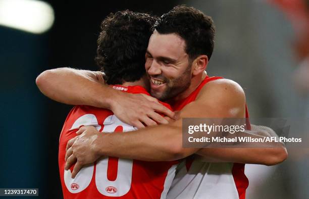 Tom McCartin of the Swans and brother Paddy embrace after the 2022 AFL Round 01 match between the GWS Giants and the Sydney Swans at Accor Stadium on...