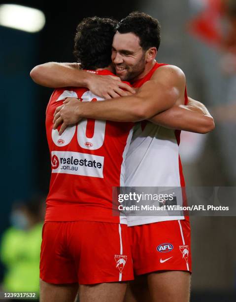 Tom McCartin of the Swans and brother Paddy embrace after the 2022 AFL Round 01 match between the GWS Giants and the Sydney Swans at Accor Stadium on...
