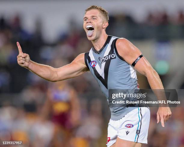 Dan Houston of the Power celebrates a goal during the 2022 AFL Round 01 match between the Brisbane Lions and the Port Adelaide Power at The Gabba on...