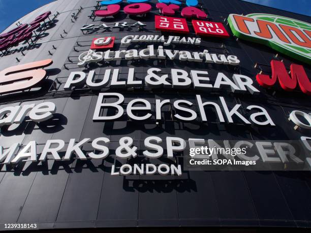 Brand names such as Marks & Spencer, Bershka, Zara, Oysho, Stradivarius, Pull&Bear, Gloria Jeans are displayed on the faÃ§ade of Salarievo, a large...