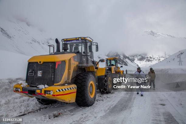 Snow plough is kept on the snow-cleared Srinagar-Leh highway on March 19, 2022 in Zojila, 108 km the Pass was opened this year after a closure of 73...