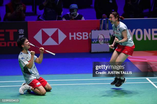 Japan's Yuta Watanabe and Japan's Arisa Higashino celebrate winning their mixed doubles semi-final against Thailand's Dechapol Puavaranukroh and...