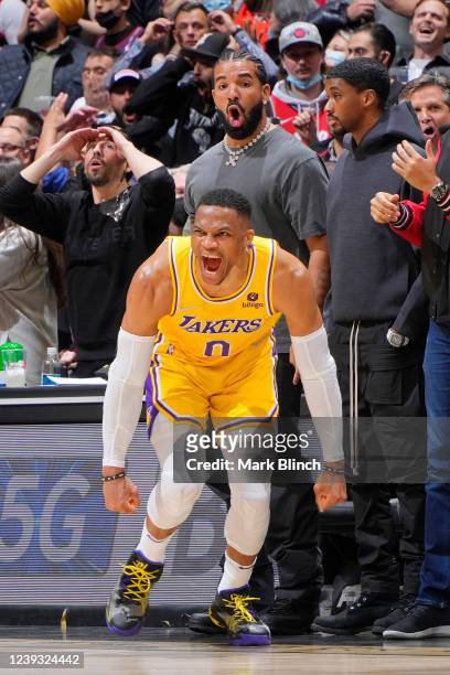 Russell Westbrook of the Los Angeles Lakers celebrates after tying the game against the Toronto Raptors with Rapper, Drake celebrating behind him on...