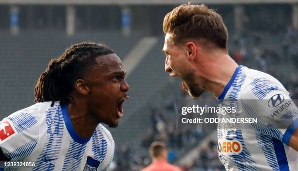 Hertha Berlin's German defender Niklas Stark celebrates scoring the 1-0 goal with Hertha Berlin's Belgian defender Dedryck Boyata during the German...