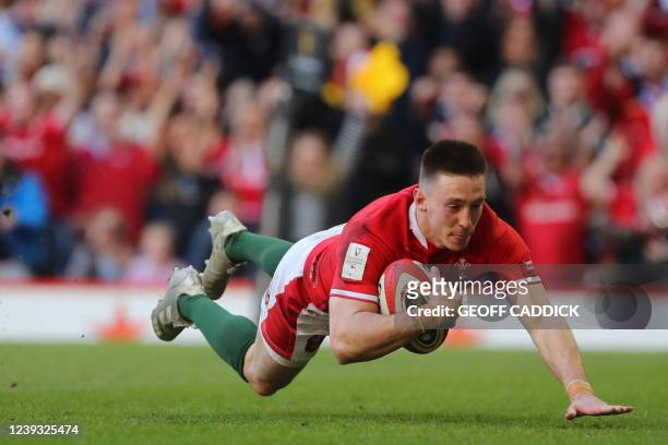 Wales' wing Josh Adams dives over the line to score a try during the Six Nations international rugby union match between Wales and Italy at the...