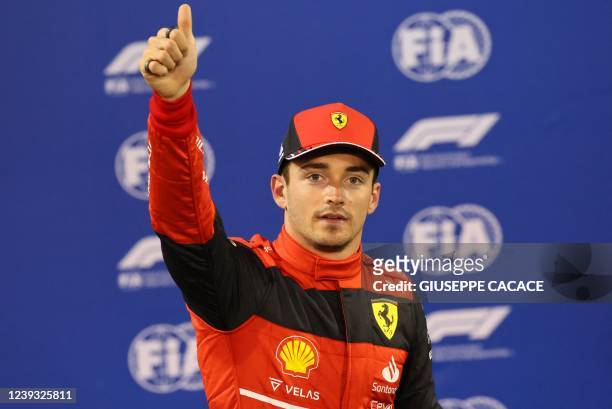 Ferrari's Monegasque driver Charles Leclerc reacts after taking pole position in the qualifying session on the eve of the Bahrain Formula One Grand...