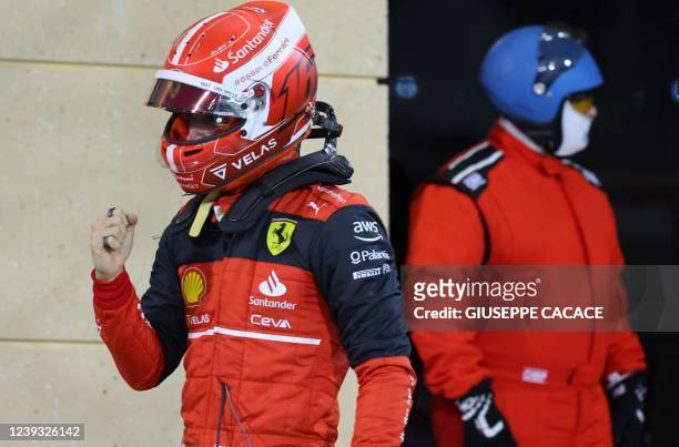 Ferrari's Monegasque driver Charles Leclerc celebrates after taking pole position in the qualifying session on the eve of the Bahrain Formula One...