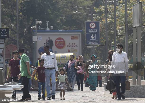 People cover themselves from heat during a hot weather at Connaught Place, on March 19, 2022 in New Delhi, India.