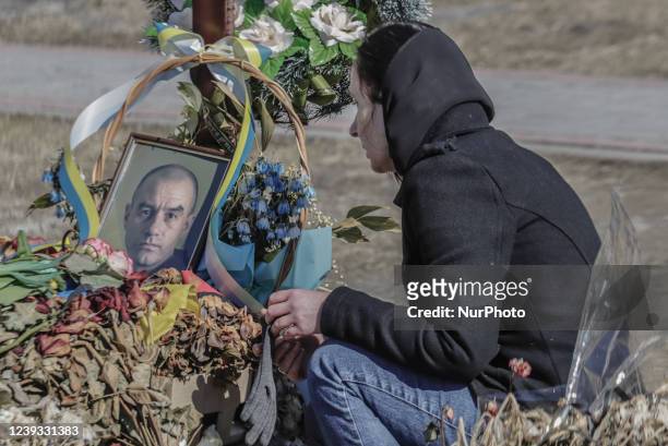 Woman nearly a picture of a killed Ukrainian soldier amid the Russian invasion of Ukraine, in Lviv, Ukraine, on March 17, 2022.