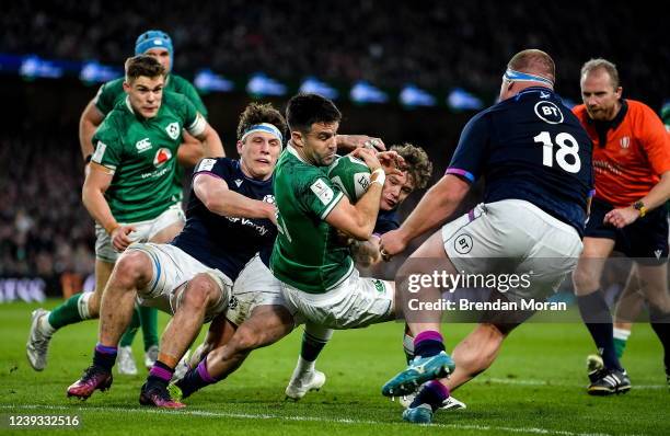 Dublin , Ireland - 19 March 2022; Conor Murray of Ireland is tackled by Rory Darge of Scotland on his way to scoring his side's fourth try during the...