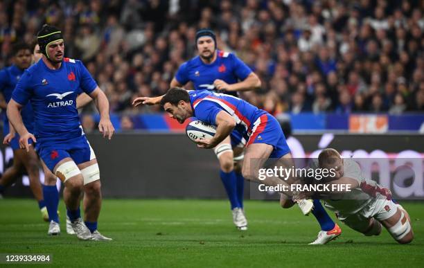 France's fullback Melvyn Jaminet is tackled by England's flanker Sam Underhill during the Six Nations rugby union tournament match between France and...