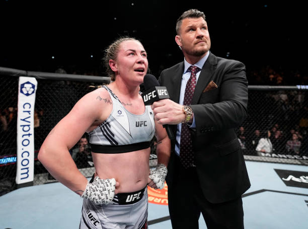 Molly McCann of England speaks with announcer Michael Bisping after knocking out Luana Carolina of Brazil in a womens flyweight fight during the UFC...