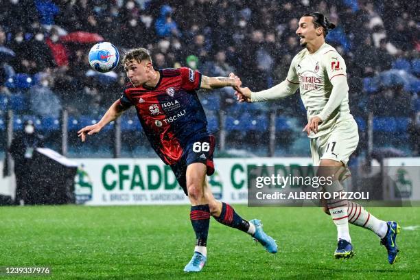 Cagliari's Italian defender Matteo Lovato and AC Milan's Swedish forward Zlatan Ibrahimovic go for the ball during the Italian Serie A football match...