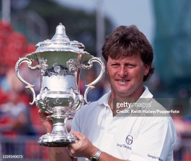 Ian Woosnam of Wales celebrates with the trophy after winning the Bell's Scottish Open at the King's Course, Gleneagles Hotel on July 14, 1990 in...