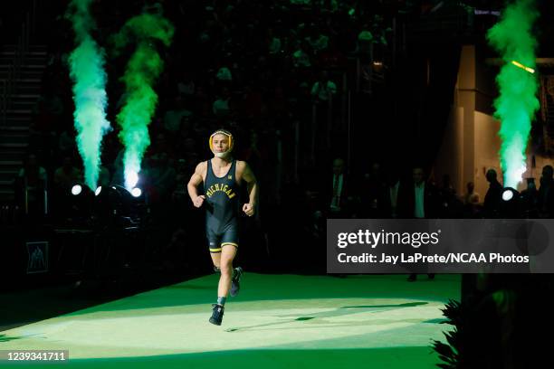 Nick Suriano of the Michigan Wolverines takes the mat to wrestle Pat Glory of the Princeton Tigers in the 125-pound final match during the Division I...