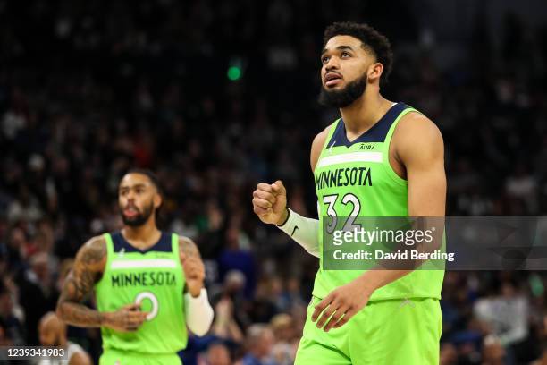 Karl-Anthony Towns celebrates recording an assist on a basket made by D'Angelo Russell of the Minnesota Timberwolves against the Milwaukee Bucks in...