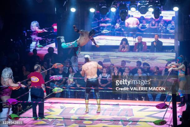 Pro-wrestlers Taya Valkyrie , Extreme Tiger and Dama Fina perform during the Mexican masked wrestling performance and comedy Lucha VaVOOM at the...