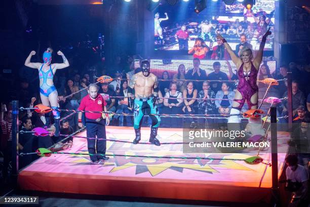 Pro-wrestlers Taya Valkyrie , Extreme Tiger and Dama Fina perform during the Mexican masked wrestling performance and comedy Lucha VaVOOM at the...