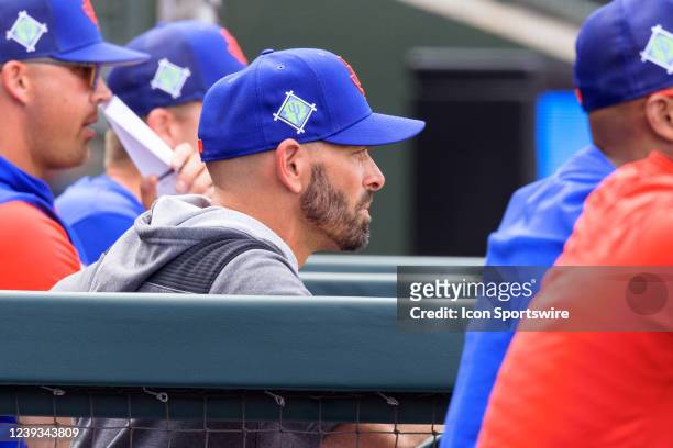 Texas Rangers manager Chris Woodward watches from the dugout during the MLB Spring Training baseball game between the Milwaukee Brewers and the Texas...