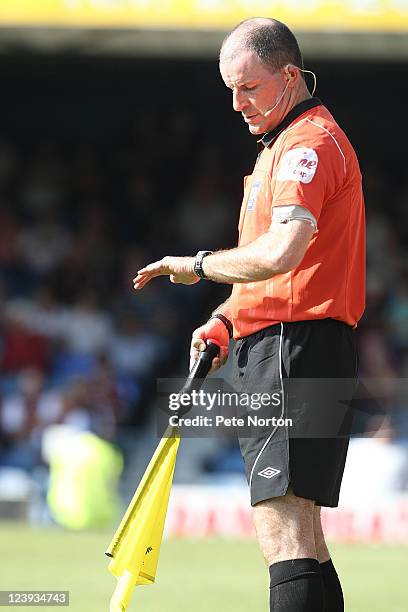 Assistant referee Graham Horwood looks at his watch during the npower League Two match between Southend United and Northampton Town at Roots Hall on...