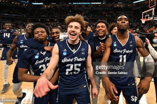 St. Peter's Peacocks players celebrate after defeating Murray State Racers in the second round of the 2022 NCAA Men's Basketball Tournament held at...