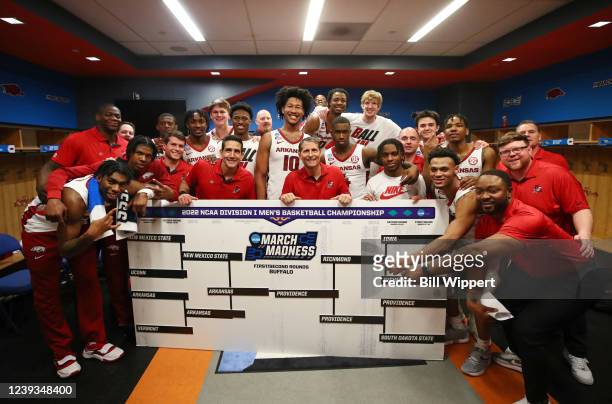 The Arkansas Razorbacks pose with their bracket board after defeating the New Mexico State Aggies 53-48 during the second round of the 2022 NCAA...