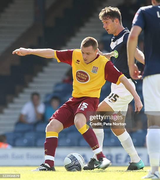 Paul Turnbull of Northampton Town attempts to play the ball under pressure from Mark Phillips of Southend United during the npower League Two match...