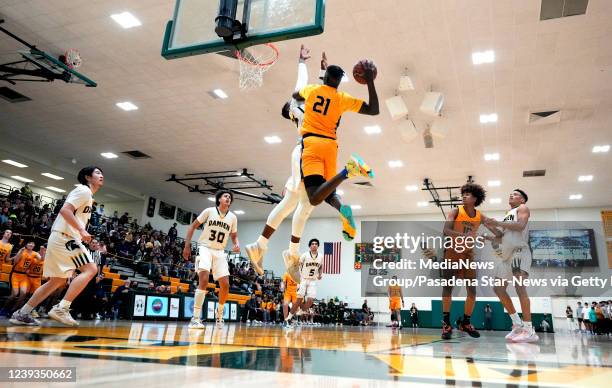 La Verne, CA Koat Keat of Crean Lutheran drives to the basket against Damien in the second half of a Division I CIF-State Regional boys basketball...