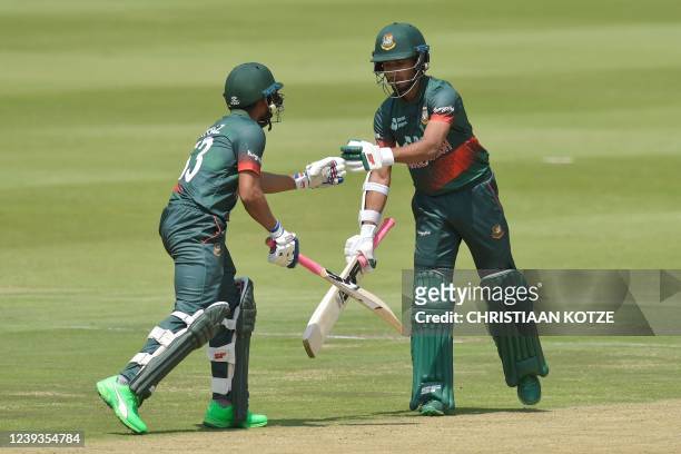 Bangladesh's Afif Hossain is congratulated by Bangladesh's Mehidy Hasan Miraz after scoring a half-century during the second one-day international...
