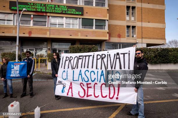 Demonstrators with a banner that reads: "Private profits leave us and dry" take part in a demonstration in front of the Mystery of Ecological...