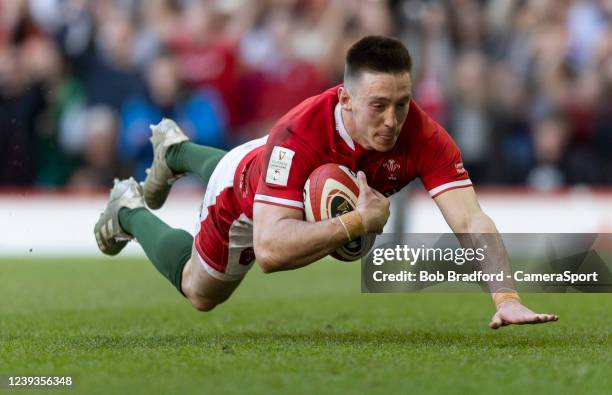 Wales Josh Adams scores his sides third try during the Six Nations Rugby match between Wales and Italy at Principality Stadium on March 19, 2022 in...
