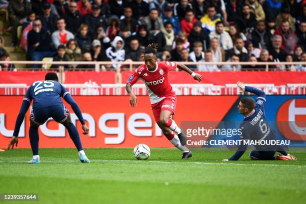 Monaco's Portuguese midfielder Gelson Batalha Martins fights for the ball with Paris Saint-Germain's Portuguese defender Nuno Mendes and Paris...