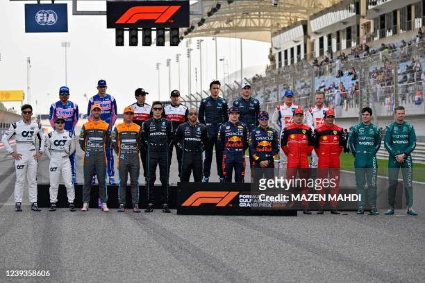 Drivers pose for a group photo ahead of the Bahrain Formula One Grand Prix at the Bahrain International Circuit in the city of Sakhir on March 20,...
