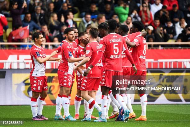 Monaco's German forward Kevin Volland celebrates with teammates after scoring the second goal during the French L1 football match between AS Monaco...