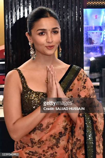 Bollywood actress Alia Bhatt poses for pictures during a promotional event of her upcoming Telugu-language period action drama film 'RRR' at a...