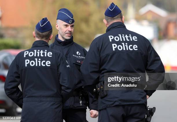 Police officers take measures at the area after a car slammed into a carnival crowd in La Louviere, Belgium on March 20, 2022. At least six people...