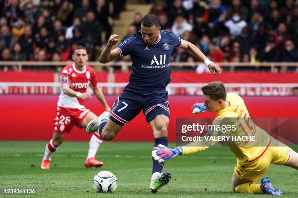 Paris Saint-Germain's French forward Kylian Mbappe fights for the ball with Monaco's German goalkeeper Alexander Nubel during the French L1 football...