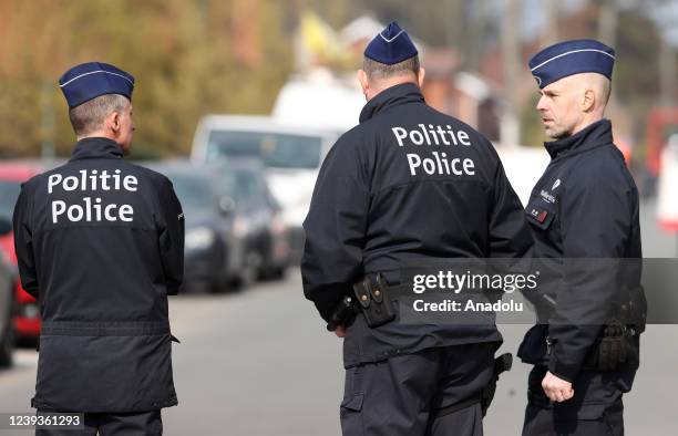 Police officers take measures at the area after a car slammed into a carnival crowd in La Louviere, Belgium on March 20, 2022. At least six people...