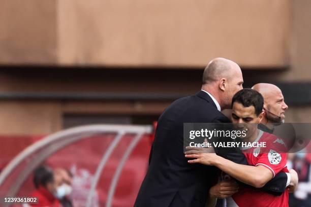 Monaco's Belgian coach Philippe Clement hugs Monaco's French forward Wissam Ben Yedder as he leaves the pitch during the French L1 football match...