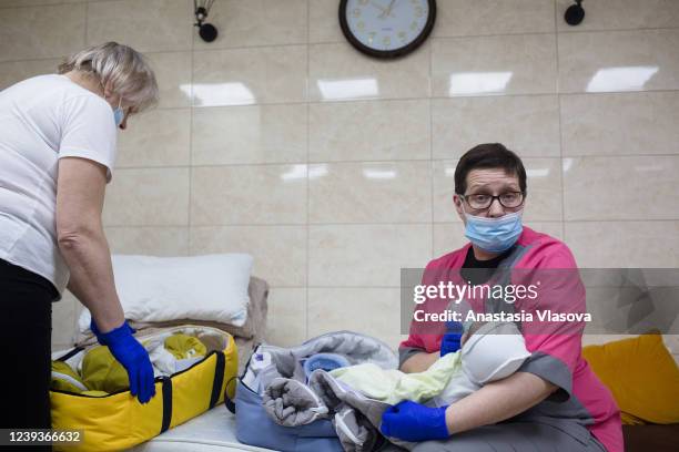 Iryna, who is a midecal nurse, feeds the baby on March 20, 2022 in Kyiv, Ukraine. Nearly 20 surrogate-born babies, along with the surrogacy center's...